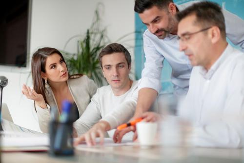 Woman uncertain about the data analyzed with colleagues