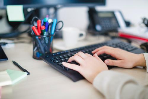 Typing on keyboard at the desk