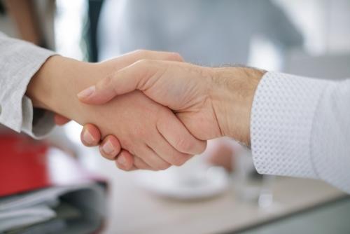 Congratulating partner with a handshake